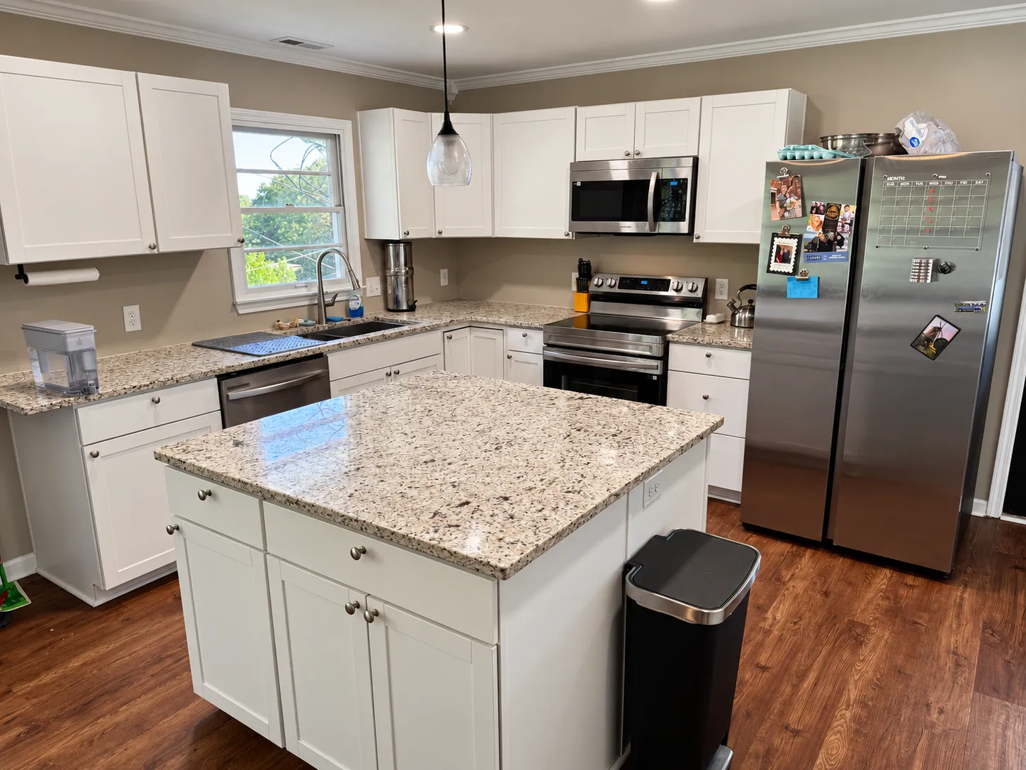 Kitchen with granite island and stainless appliances